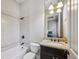 Clean bathroom with tile backsplash, granite countertop, and an appealing light fixture above the mirror at 3113 Lenox Ne Rd # 6, Atlanta, GA 30324