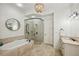Elegant bathroom featuring a soaking tub, glass shower, and double vanity sinks with stone countertops at 3113 Lenox Ne Rd # 6, Atlanta, GA 30324