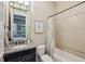 Stylish bathroom with granite countertops, a bathtub, and a decorative light fixture above the mirror at 3113 Lenox Ne Rd # 6, Atlanta, GA 30324