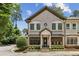 Charming brick townhome featuring manicured landscaping, stately pillars and decorative window accents at 3113 Lenox Ne Rd # 6, Atlanta, GA 30324
