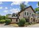 Elegant brick townhome with arched windows, manicured shrubs and stone steps at 3113 Lenox Ne Rd # 6, Atlanta, GA 30324