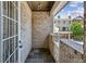 Charming brick-paved front porch with decorative railing, and a view of the neighboring building's facade at 3113 Lenox Ne Rd # 6, Atlanta, GA 30324