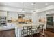 Open-concept kitchen with granite island, stainless steel appliances, and modern pendant lighting at 3113 Lenox Ne Rd # 6, Atlanta, GA 30324