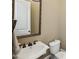 Cozy powder room featuring vintage-style fixtures and a decorative framed mirror and light fixtures at 3113 Lenox Ne Rd # 6, Atlanta, GA 30324
