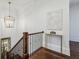 Elegant staircase with wood treads, iron railings, decorative chandelier, and marble accent table at 3113 Lenox Ne Rd # 6, Atlanta, GA 30324