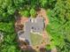 Aerial view of the home and surrounding wooded lot with circular driveway and landscaping at 2170 Jonquil Ct, Canton, GA 30115