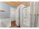 Bathroom featuring a shower, wood-look floors, and charming blue walls at 2170 Jonquil Ct, Canton, GA 30115