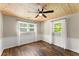 Bedroom featuring hardwood floors, bright windows, and a ceiling fan at 2170 Jonquil Ct, Canton, GA 30115