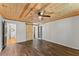 Bedroom with a wood ceiling, modern ceiling fan, and a barn door leading to the bathroom at 2170 Jonquil Ct, Canton, GA 30115