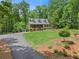 Beautiful home nestled in a lush, wooded setting with a long driveway and well-kept landscaping at 2170 Jonquil Ct, Canton, GA 30115