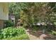 Serene backyard with mature trees, lush greenery, a screened porch, and a covered patio for relaxing at 2384 Shadowood Sw Dr, Conyers, GA 30094