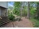 Backyard featuring multiple levels, a picnic table, swing set, and steps leading down to a wooded area at 2384 Shadowood Sw Dr, Conyers, GA 30094