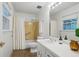 Bathroom features a shower over tub with yellow tile and window allowing for natural light at 2384 Shadowood Sw Dr, Conyers, GA 30094