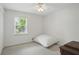 Bedroom with a ceiling fan, large window and carpeted flooring at 2384 Shadowood Sw Dr, Conyers, GA 30094