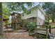 Exterior view featuring multiple decks and lush landscaping creating an inviting outdoor living space at 2384 Shadowood Sw Dr, Conyers, GA 30094