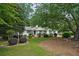 Well-maintained, single-story home with lush landscaping, a welcoming front yard, and mature trees at 2384 Shadowood Sw Dr, Conyers, GA 30094