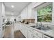 Bright kitchen featuring white cabinetry, stainless appliances, with seamless open plan to living area at 2384 Shadowood Sw Dr, Conyers, GA 30094