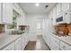 Well-lit kitchen with tile backsplash, white cabinetry, and stainless steel appliances at 2384 Shadowood Sw Dr, Conyers, GA 30094