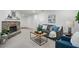Comfortable living room with a stone fireplace, plush seating, and a seamless transition into the adjacent dining space at 2384 Shadowood Sw Dr, Conyers, GA 30094