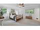 A bright main bedroom features a ceiling fan and warm natural light from two windows at 2384 Shadowood Sw Dr, Conyers, GA 30094