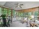 Enclosed sunroom with large windows, ceiling fan, and comfortable seating, ideal for relaxing and enjoying natural light at 2384 Shadowood Sw Dr, Conyers, GA 30094