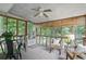 Cozy sunroom with large windows providing natural light and views of the surrounding trees and backyard at 2384 Shadowood Sw Dr, Conyers, GA 30094