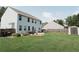 Large backyard with a spacious lawn, a patio area, and a storage shed, ideal for outdoor activities at 258 Creek View Ln, Acworth, GA 30102