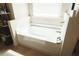 Bathroom featuring a bright white soaking tub beneath a window with blinds at 258 Creek View Ln, Acworth, GA 30102