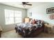 Comfortable bedroom with a double window, ceiling fan, and an accent Captain America shield at 258 Creek View Ln, Acworth, GA 30102
