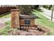 Elegant stone entrance sign for the 'Parc at Kellogg Creek' community, surrounded by flowers at 258 Creek View Ln, Acworth, GA 30102