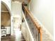 Inviting foyer with a staircase featuring wooden handrails and an adjacent arched entryway at 258 Creek View Ln, Acworth, GA 30102