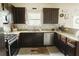Well-equipped kitchen with dark cabinets, stainless steel appliances, and granite countertops at 258 Creek View Ln, Acworth, GA 30102