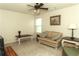 Cozy living room with a plaid sofa, ceiling fan, and neutral carpet at 258 Creek View Ln, Acworth, GA 30102