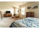 Sunlit primary bedroom with a calm color palette, ceiling fan, and comfortable rocking chair at 258 Creek View Ln, Acworth, GA 30102