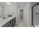Bathroom featuring double sinks, modern fixtures, and a glass-enclosed shower at 2700 Westgate Park Dr, Loganville, GA 30052