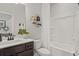 Modern bathroom with a vanity, decorative shelving, and a shower-tub combination with a white shower curtain at 2700 Westgate Park Dr, Loganville, GA 30052