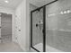 Walk in shower with gray tile and black hardware at 2700 Westgate Park Dr, Loganville, GA 30052