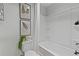 Bathroom with tub-shower combo, white tile, and stylish decor at 2700 Westgate Park Dr, Loganville, GA 30052