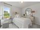 Modern bedroom with white bedding, desk and natural light from large window at 2700 Westgate Park Dr, Loganville, GA 30052