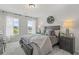 Bedroom with gray carpet and stylish bed in a light and airy setting with two large windows at 2700 Westgate Park Dr, Loganville, GA 30052