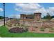 Westgate community entrance featuring brick signage and manicured landscaping with colorful flowers at 2700 Westgate Park Dr, Loganville, GA 30052