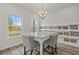 Dining area with gray chairs and granite countertop table near window and samples at 2700 Westgate Park Dr, Loganville, GA 30052