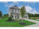 Inviting two-story home featuring lush green grass, artful landscaping, and a wide, paved driveway at 2700 Westgate Park Dr, Loganville, GA 30052