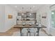 Open-concept kitchen boasts gray cabinets, granite countertops, stainless appliances and an island with bar seating at 2700 Westgate Park Dr, Loganville, GA 30052