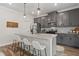 Modern kitchen featuring gray cabinetry, granite countertops, stainless steel appliances, and a convenient breakfast bar at 2700 Westgate Park Dr, Loganville, GA 30052