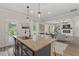 Granite countertop on kitchen island with stainless appliances, opens up to living room with fireplace and coffered ceilings at 2700 Westgate Park Dr, Loganville, GA 30052