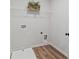 A functional laundry room with wood-look floors at 2700 Westgate Park Dr, Loganville, GA 30052
