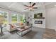 Bright living room featuring a fireplace and a view of the backyard at 2700 Westgate Park Dr, Loganville, GA 30052