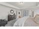 Main bedroom with tray ceiling, gray carpet, and plenty of natural light coming from open doorway at 2700 Westgate Park Dr, Loganville, GA 30052