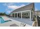 Exterior view of pool house with lounge chairs and tables provides a comfortable place for socializing at 2700 Westgate Park Dr, Loganville, GA 30052